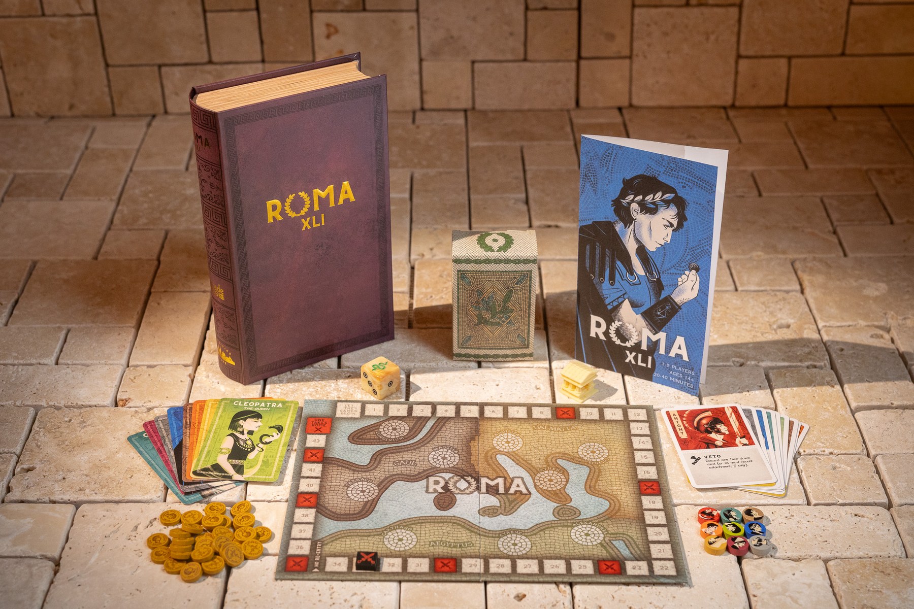 Roma XLI components laid out — book, board, cards, coins and pawns